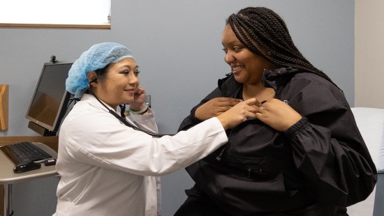 Doctor checking a patient's heart beat